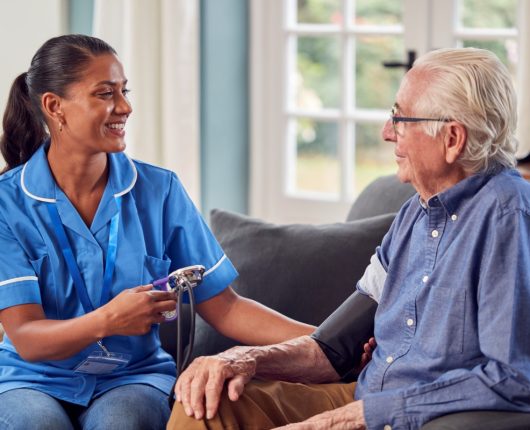 senior-man-at-home-in-lounge-having-blood-pressure-2024-10-21-16-42-10-utc